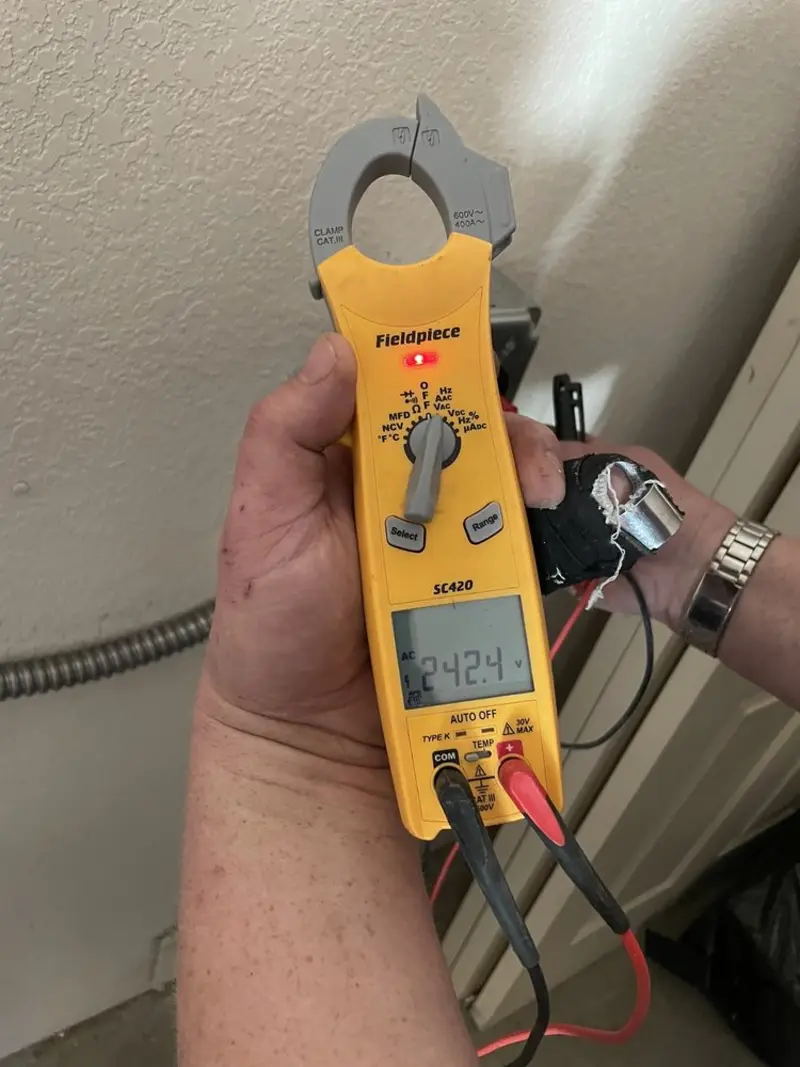 Voltage testing with clamp meter during Electrical Installation Services in Whitehall